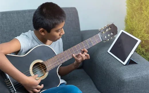 a boy playing a guitar