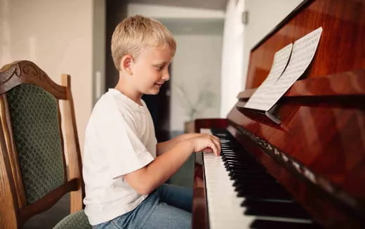 a boy playing a piano