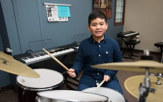 a boy playing drums