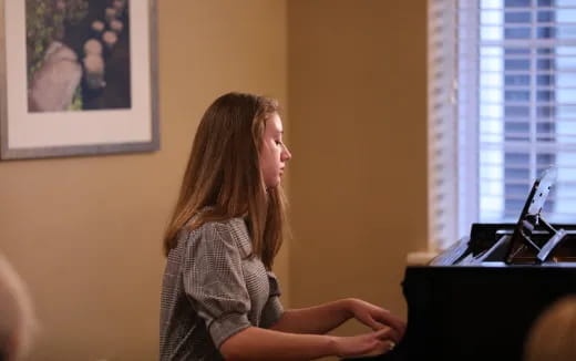 a woman sitting in front of a laptop