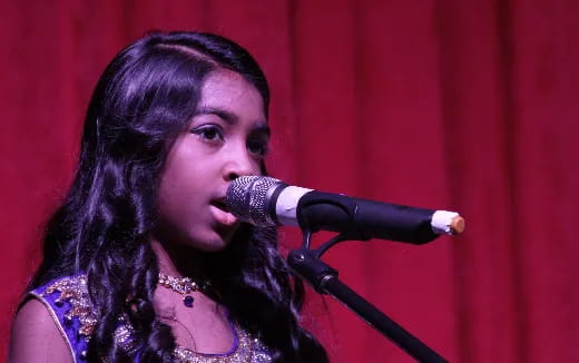 a person singing into a microphone