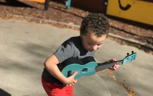 a boy playing a guitar