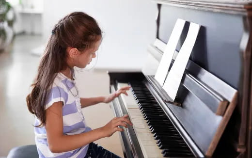 a girl playing a piano
