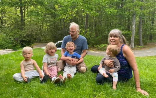 a family sitting on the grass