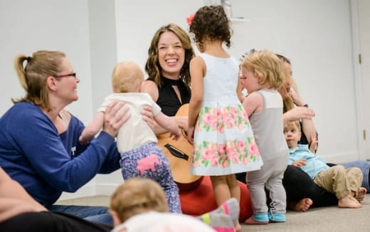 a person holding a baby and a group of children