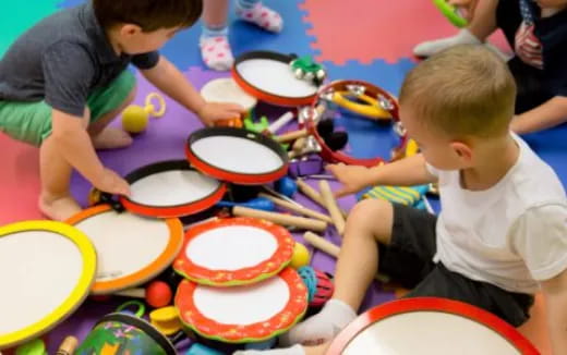 a group of kids playing with colorful plates