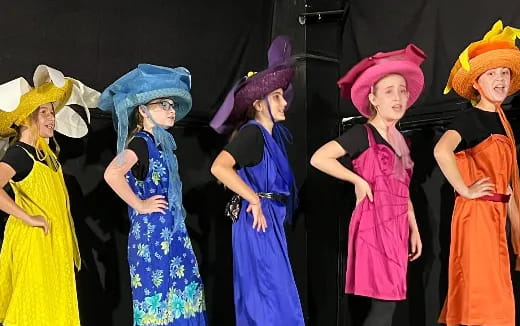 a group of women wearing colorful dresses