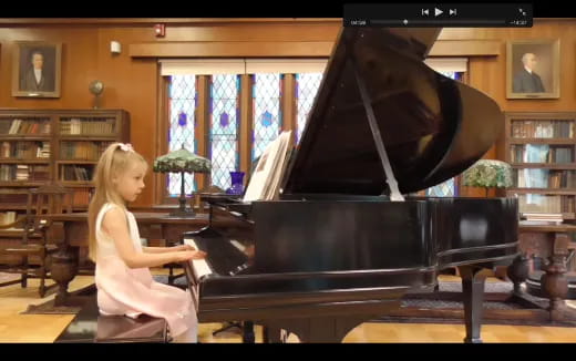 a girl playing a piano