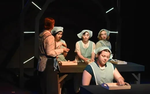 a group of women sitting at desks