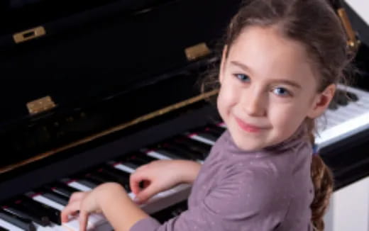 a girl playing a piano