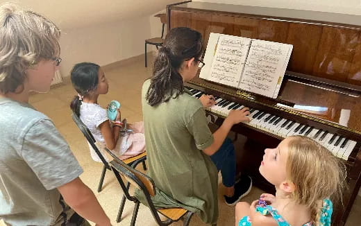 a group of people playing piano