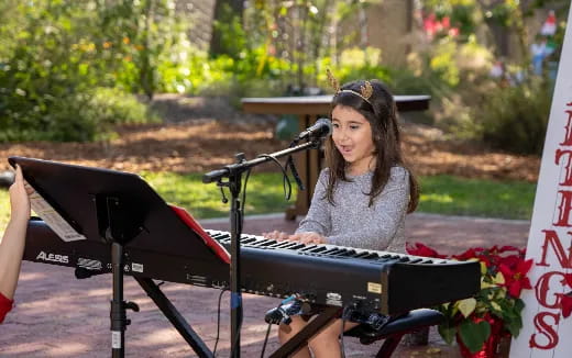 a woman playing a piano