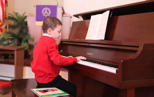 a boy playing a piano