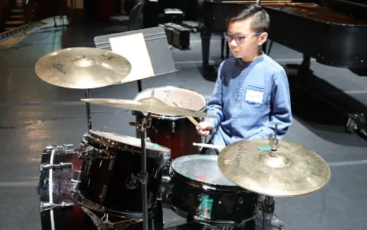 a boy playing drums