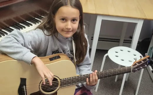 a girl playing a guitar