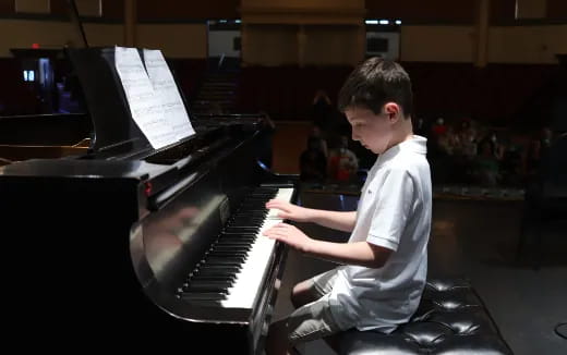 a boy playing a piano