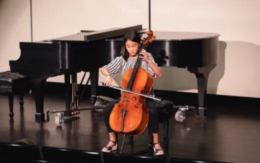 a person playing a cello