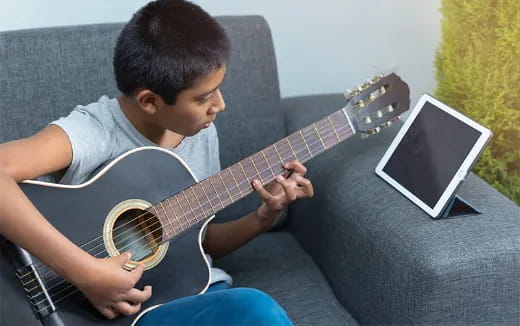 a boy playing a guitar