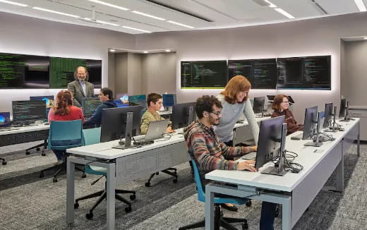 a group of people sitting at computers