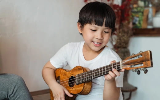 a child playing a guitar