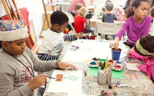 a group of children painting