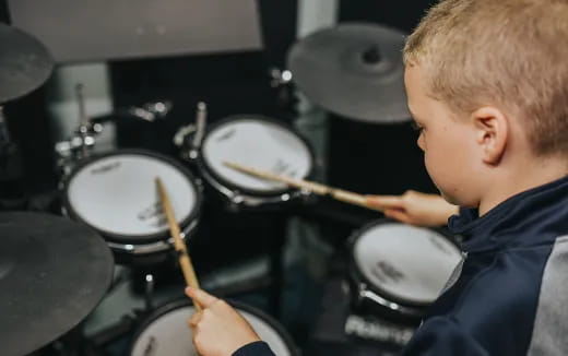 a boy playing drums