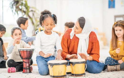 a group of children playing drums