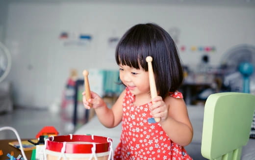 a little girl holding a spoon