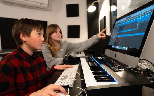 a man and a woman playing a piano