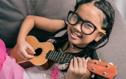 a girl playing a guitar