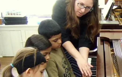 a group of people playing piano