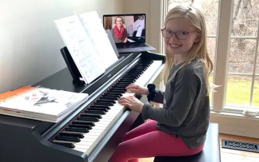 a girl playing a piano