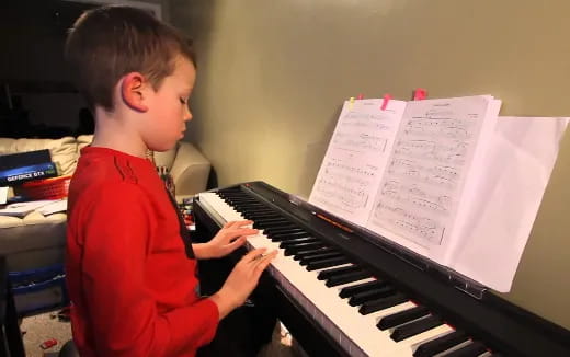 a boy playing a piano