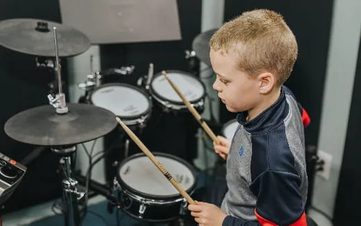 a boy playing drums
