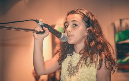 a person singing into a microphone