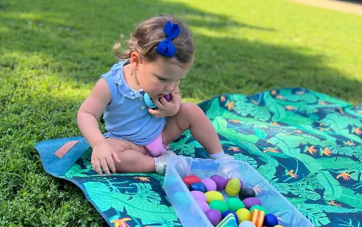a baby playing with balls