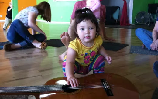 a young girl playing a guitar