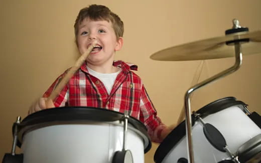 a boy playing drums