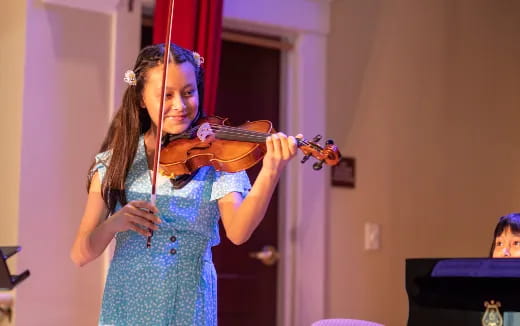 a girl playing a violin