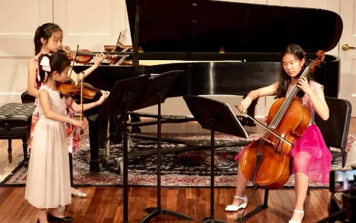 a group of girls playing the violin