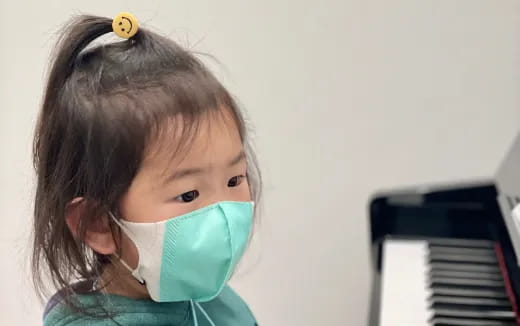 a young girl with a bird on her head