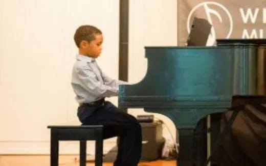 a person sitting on a stool