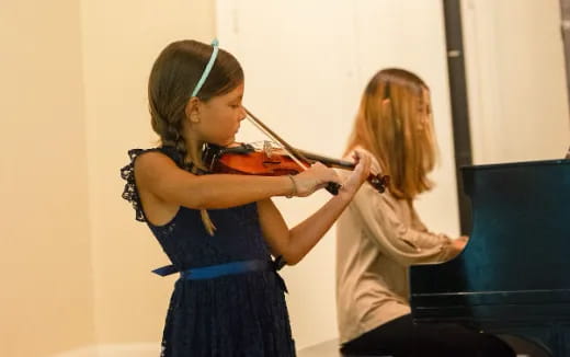 a woman playing a violin