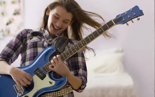 a woman playing a guitar