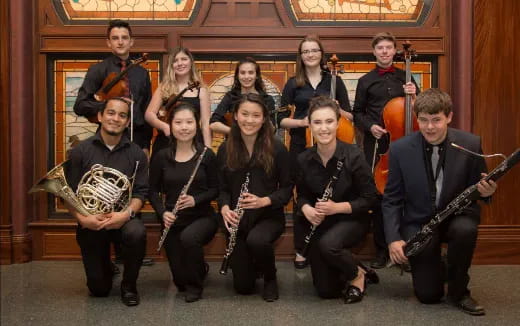 a group of people holding instruments