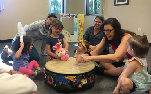 a group of people around a cake
