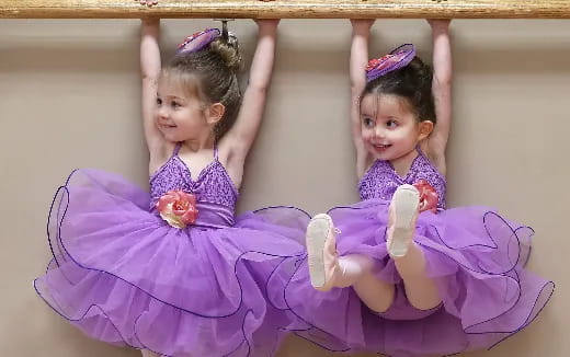a couple of girls in purple dresses