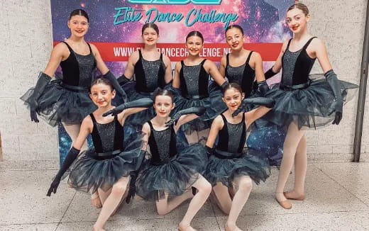 a group of women in black dresses