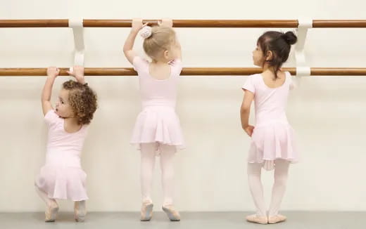 a group of girls in white dresses