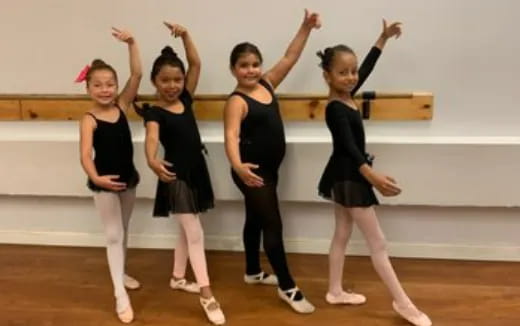 a group of girls in black dresses